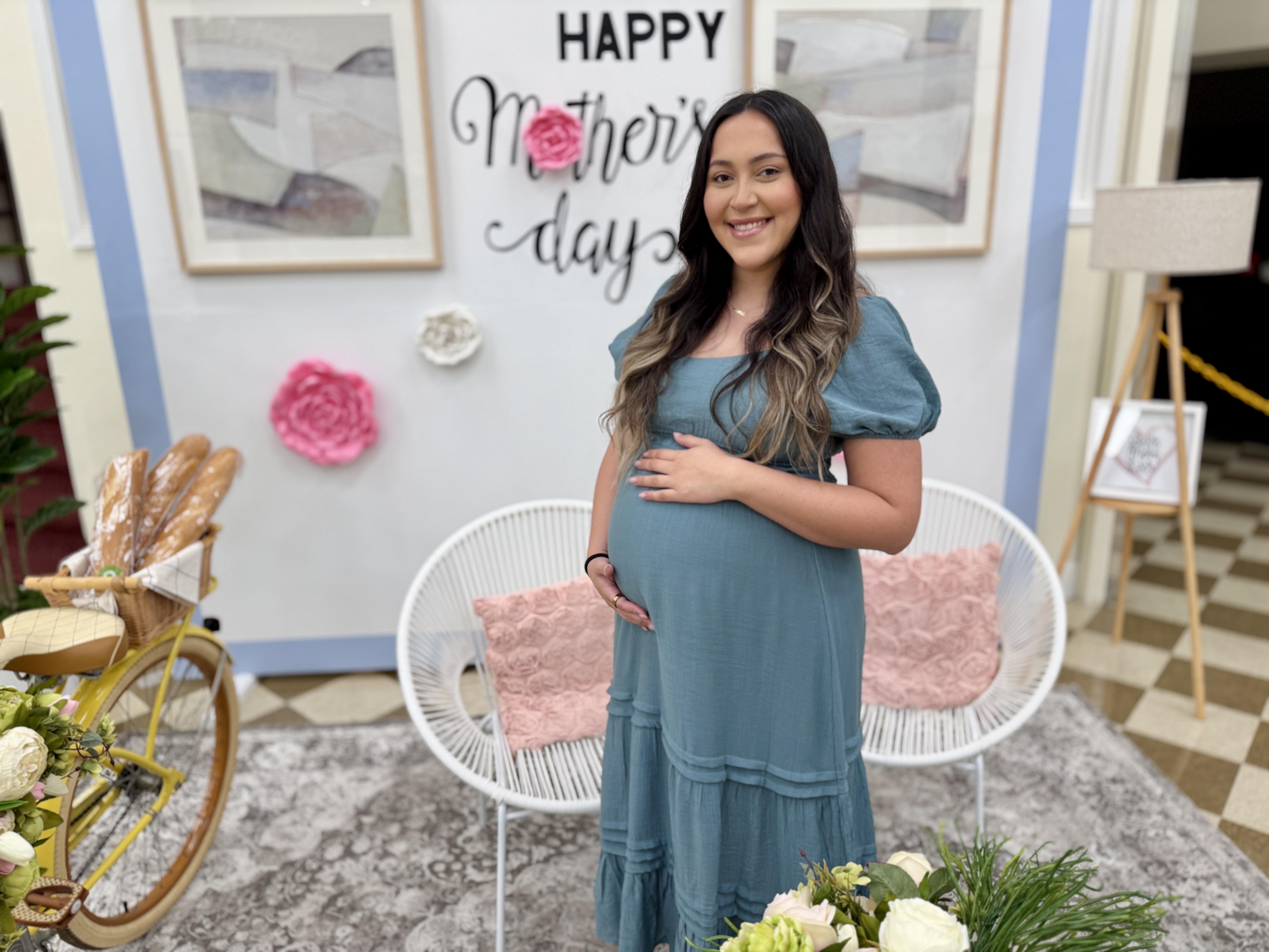 Ale smiling in a teal dress